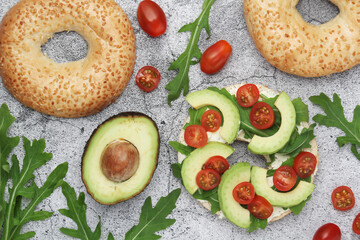 Sesame bagels with tomatoes and avocado