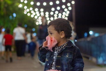The little boy eats sweets in the night