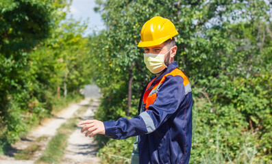 construction worker with yellow helmet and medical mask, construction worker in work