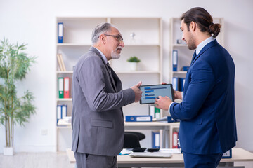 Boss and his assistant discussing company results