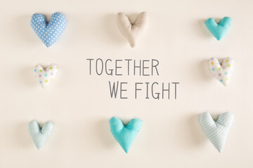 Together We Fight message with blue heart cushions on a white paper background