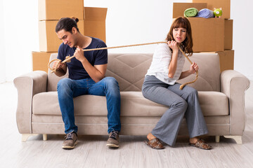 Young pair and many boxes in divorce settlement concept