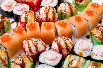 set of different types of sushi on a white plate