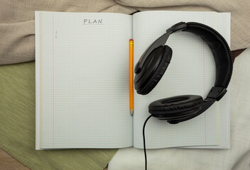 Headphones with notepad and pencil