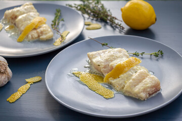 White fish with creamy sauce and lemon