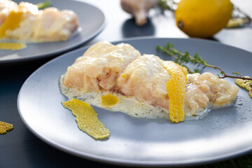 White fish with creamy sauce and lemon