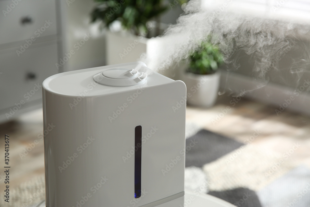 Sticker modern air humidifier at home, closeup view