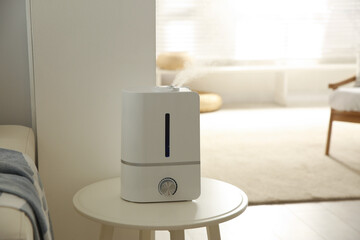 Modern humidifier on table indoors. Space for text