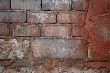 Brick wall with red paint spots