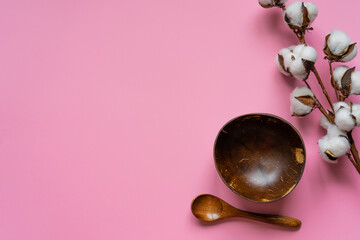 Eco-friendly tableware made from coconut on a pink background
