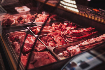 Butcher shop's counter with cold raw meat. Meat business. Selected quality meat selling.