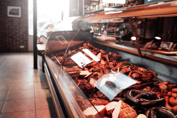 Huge assortment of meat selection. A shop with a row of stalls full of meat. Butcher shop inside.