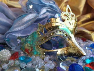 Gold carnival mask on a blue and gold christmas background
