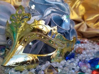 Gold carnival mask on a blue and gold christmas background
