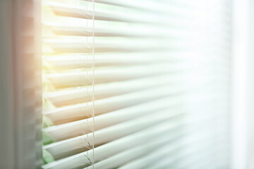 Window with blinds on sunny day, closeup