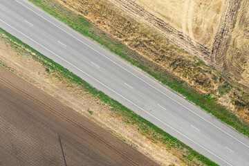 Rural road between agriculture fields. Aerial view.
