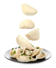 Many tasty dumplings falling on white background
