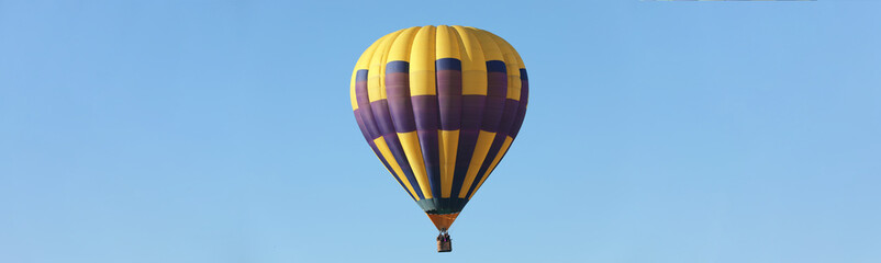 Fototapeta premium Hot air balloon in blue sky. Banner design