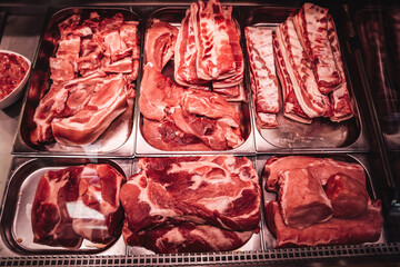 Red raw meat shop window. Fresh and cool meat collection. Meat shop. A full-filled with cold meat fridge.