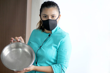 latin woman chef preparing whipping flour for cake with kitchen utensils