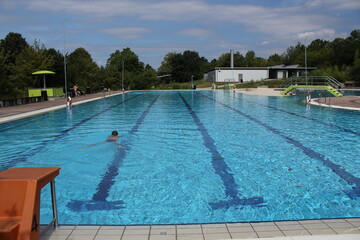 big empty swimming pool in summer with lifebuoy