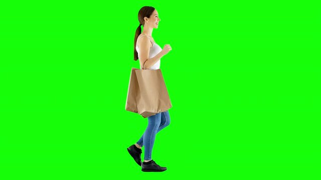 Casual Woman Walking Back From Shopping Carrying Paper Bags Green Screen