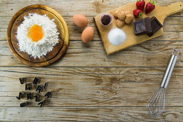 Ingredients of sweets of the Italian tradition with eggs, chocolate and flour.top view
