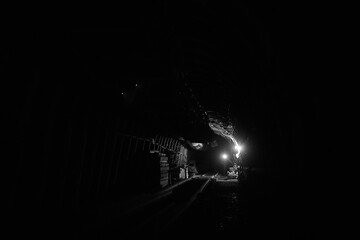 Silhouette of a working miner in a mine