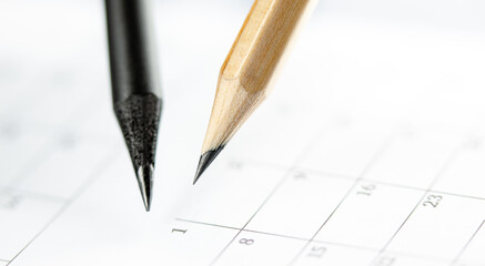 Close Up of dark and light pencils on white paper of calendar. Concept of The National Day of...