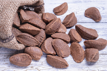 Paranuts in bag, vegetarian food on old wooden background