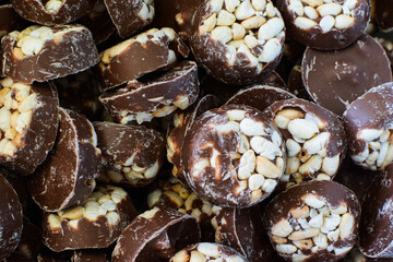 Chocolates with rice crispy. Traditional Scandinavian sweets. Backgrounds, textures