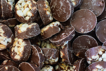 Chocolates with rice crispy. Traditional Scandinavian sweets. Backgrounds, textures