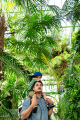 father and son in the palm greenhouse of the Botanical garden