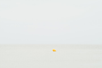 Fototapeta na wymiar Yellow marker buoy in the sea