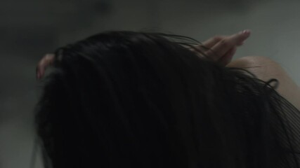 Modern dancer leans back, dancing with passion and energy in industrial warehouse