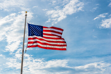 The American flag against a blue sky.