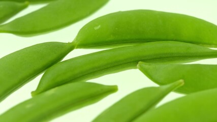 Green fresh peas lying on white background. Veggie food in grocery.