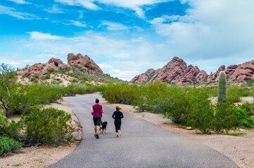 A couple and their dog jogging in Phoenix, Arizona
