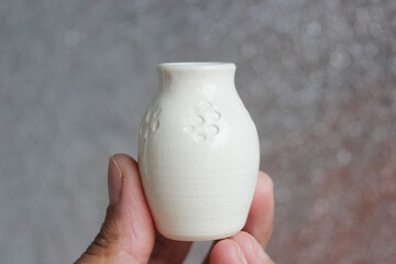 small handmade white clay with cat paws pot for making wishes or flowers from boutonnieres. Decor transparent glaze, two firing
