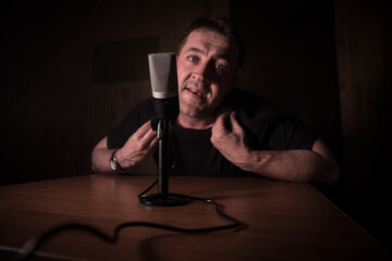 Serious reporter in television studio looking at the camera