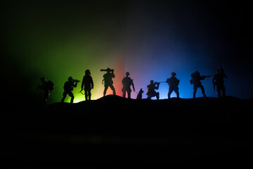Fototapeta na wymiar Azeri army concept. Silhouette of armed soldiers against Azerbaijani flag. Creative artwork decoration. Military silhouettes fighting scene dark toned foggy background.