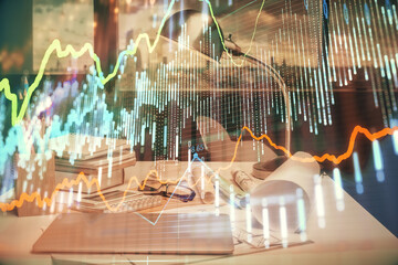 Double exposure of stock market graph drawing and office interior background. Concept of financial analysis.