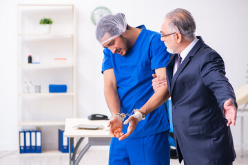 Fototapeta premium Male doctor in courthouse meeting with advocate
