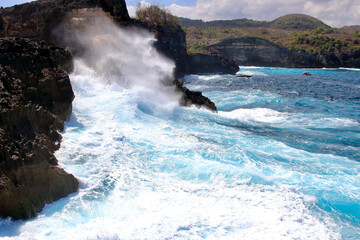 Indic sea waves hitting the cliff rocks at Angel’s Billabong point, an amazing spot close to Broken beach in Nusa Penida Island, Indonesia.