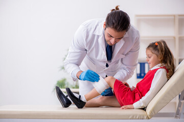 Small girl visiting young male doctor