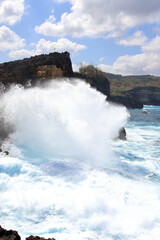Indic sea waves hitting the cliff rocks at Angel’s Billabong point, an amazing spot close to Broken beach in Nusa Penida Island, Indonesia.