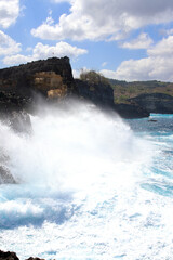 Indic sea waves hitting the cliff rocks at Angel’s Billabong point, an amazing spot close to Broken beach in Nusa Penida Island, Indonesia.