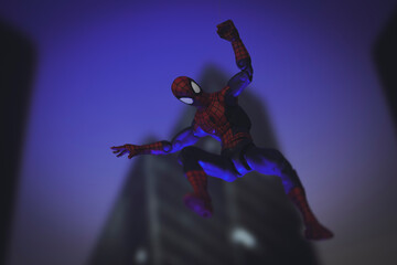 Obraz premium NEW YORK USA - AUGUST 9 2020: Marvel comics superhero Spiderman swinging from a web at night - Hasbro action figure