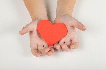 Hands Holding a Paper Heart