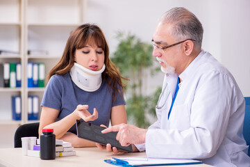 Young woman after accident visiting old doctor